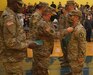 Capt. James Goslin, commander of the 228th Engineer Company, pins an award onto Cpl. Nicholas Nye, for his work during the training in preparation for their deployment during departure ceremony on October 10, 2021. The Soldiers were supported by friends, family, and fellow service members, that attended to support the Soldiers of the 228th on their mission (U.S. Army photo by Sgt. 1st Class Matthew Keeler).
