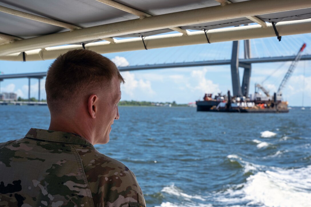 Lt. Col. Andrew Johannes, the commander for the U.S. Army Corps of Engineers Charleston District, observes a dredger under the Arthur Ravenel Jr. Bridge during a tour of the Charleston Harbor Post 45 Deepening Project.