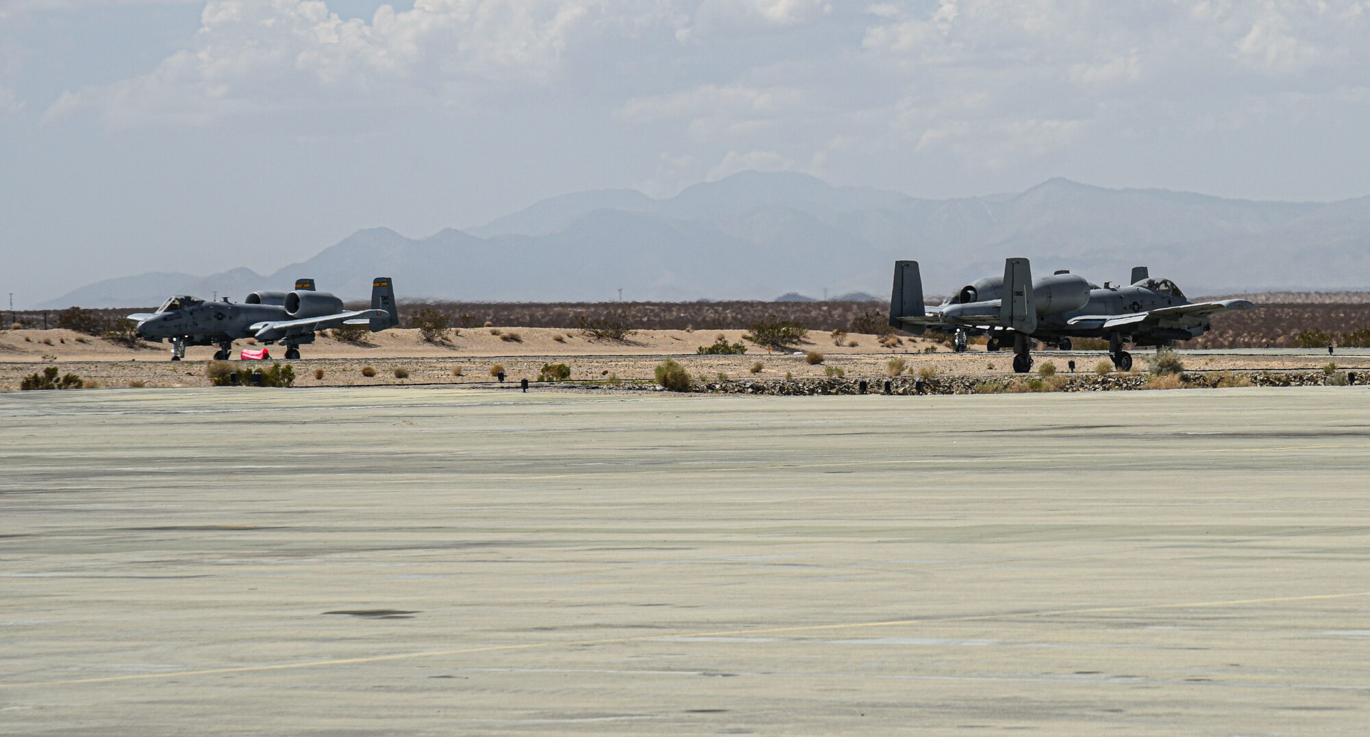 Pictured above are two aircraft drive down a taxiway after landing.