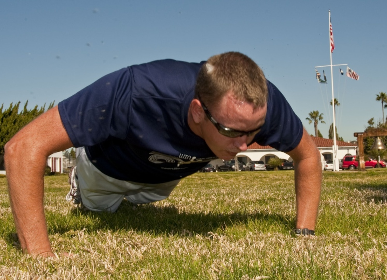 SAN DIEGO - U.S. Coast Guard Petty Officer 2nd Class Matthew Fritchey, a marine science technician assigned to Sector San Diego, does pushups on the parade field at the sector, Monday, Feb. 7, 2010. Fritchey is building up points, which will be converted to miles in hopes of his team winning the D11 Admiral's physical fitness challenge. U. S. Coast Guard photo by Petty Officer 2nd Class Jetta H. Disco.