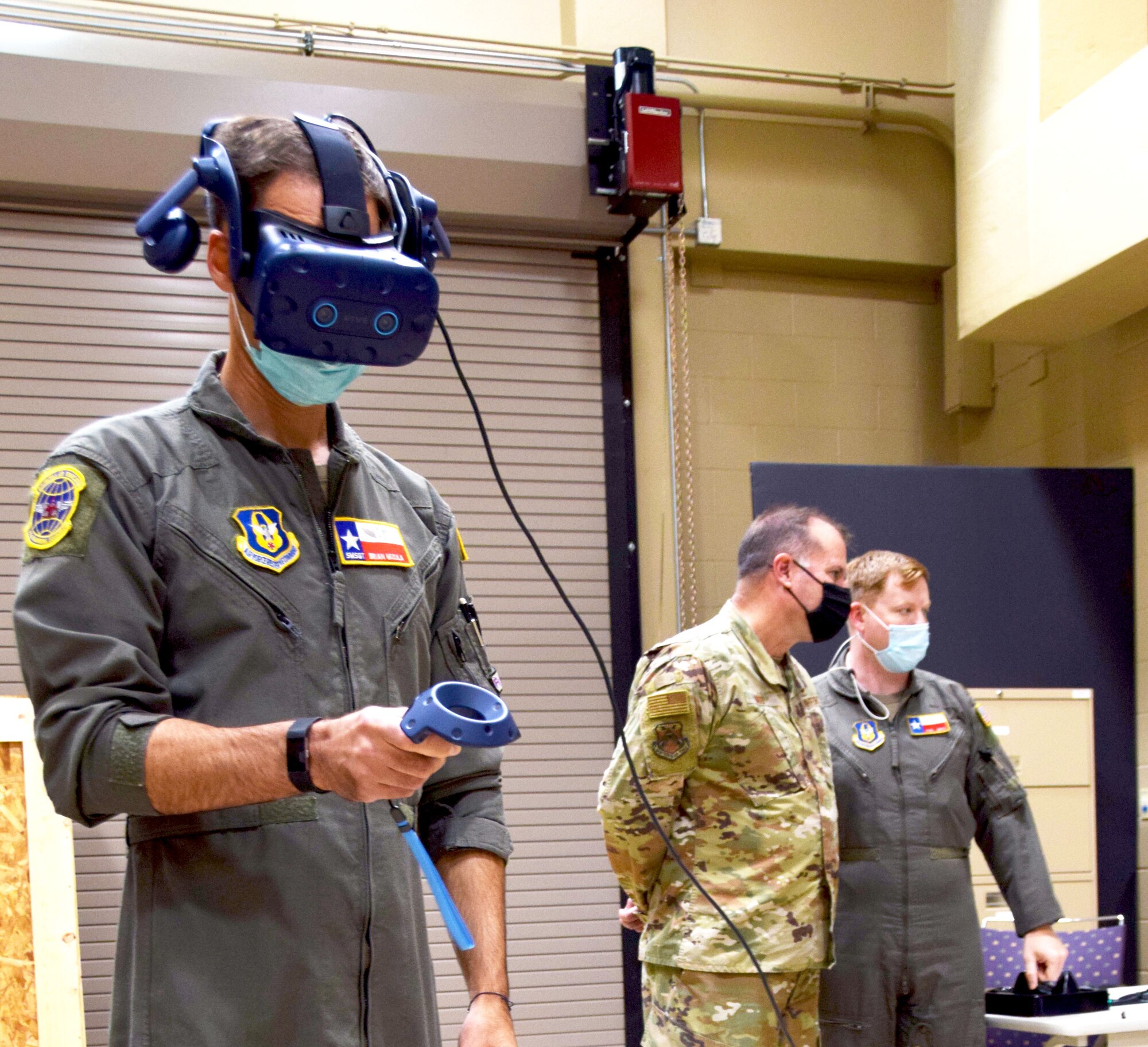 Senior Master Sgt. Brian Mizula, 733rd Training Squadron superintendent, demonstrates use of virtual reality equipment as a learning tool Oct. 14, 2021, while Maj. Gen. Kenneth Bibb Jr., 18th Air Force commander, receives a brief from Maj. Paul Lentz, 733rd TRS student flight commander, at Joint Base San Antonio-Lackland, Texas. (U.S. Air Force photo by Lt. Col. Tim Wade)
