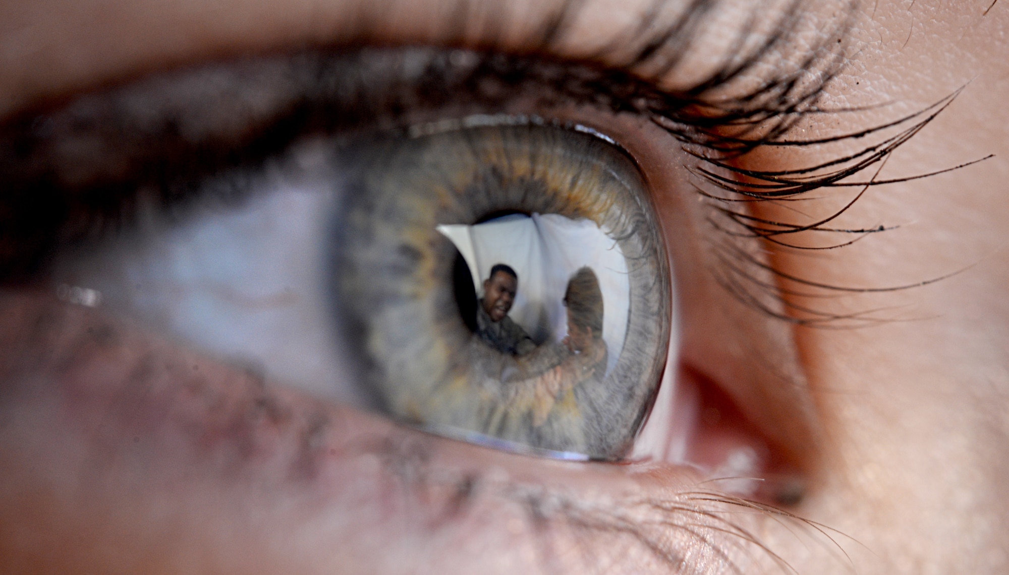 Eye with reflections of angry man