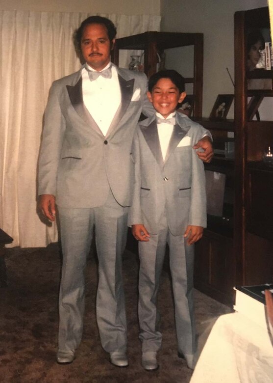 Cordell Hull Lake Park Ranger Luke Navarro as a child, poses with his father, Ernesto, for a picture as they prepare for a family wedding.