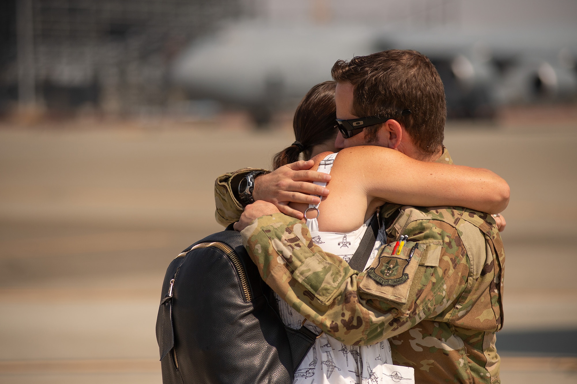 Maj. Dominic Calderon, a pilot from the 301st Airlift Squadron, embraces his wife upon arrival at Travis Air Force Base, California, September 14, 2021. Calderon's C-17 Globemaster III aircrew helped evacuate hundreds of American citizens, Special Immigrant Visa applicants and vulnerable Afghans from Afghanistan in support of Operation Allies Welcome