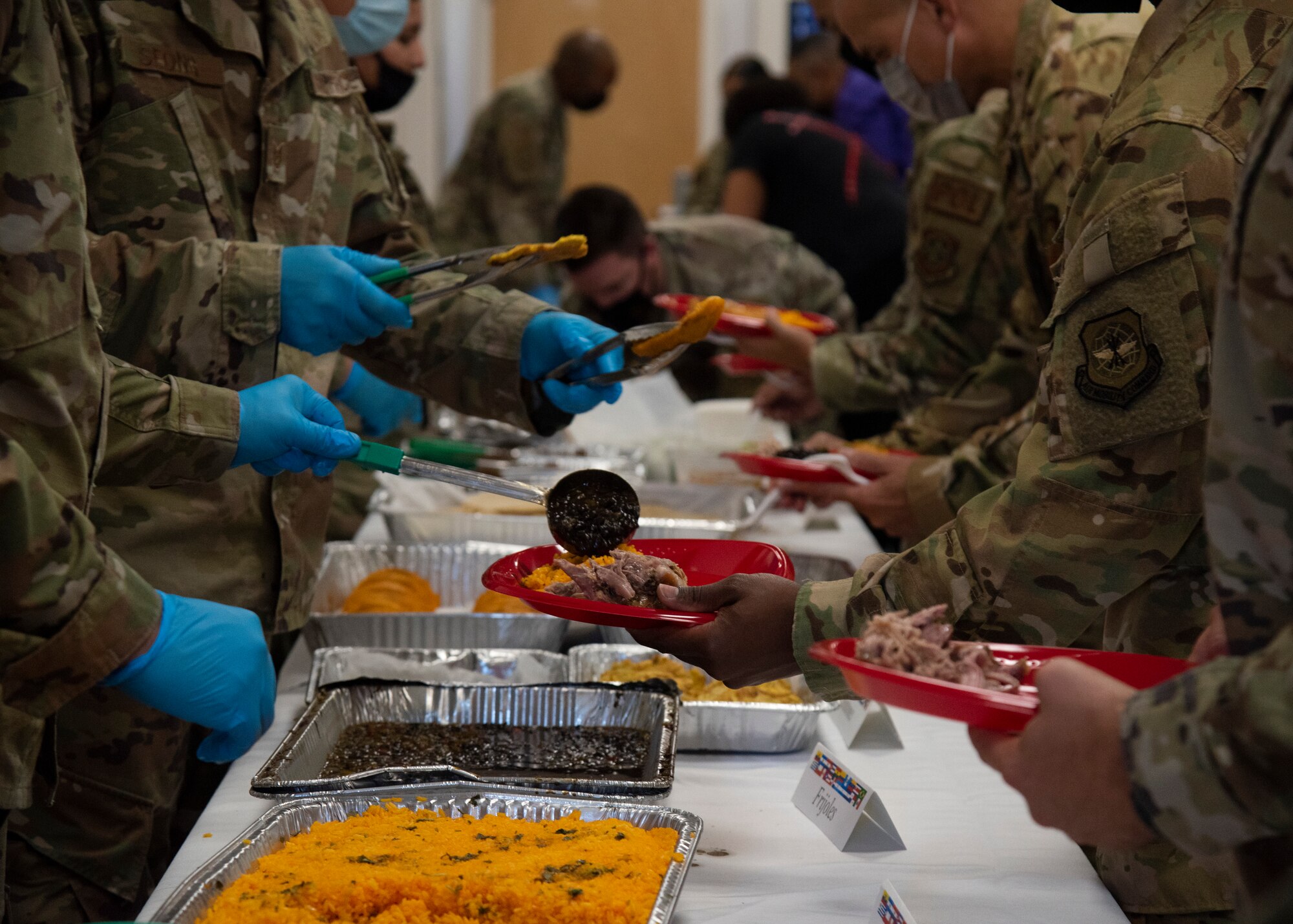 U.S Air Force Airmen serve each other food and refreshments at the Hispanic Heritage Month celebration at MacDill Air Force Base, Florida, Oct. 14, 2021.