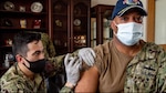 Capt. David Adams, commander, Fleet Activities Sasebo (CFAS), receives an influenza vaccine from Hospital Corpsman 3rd Class David Manes at CFAS Sept. 29, 2021. Active duty personnel are required to be vaccinated annually prior to the winter flu season (Photo by: Navy Petty Officer 3rd Class Jasmine Ikusebiala).