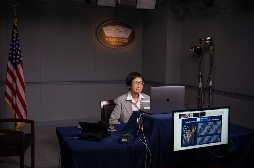 A woman speaks at a virtual conference.