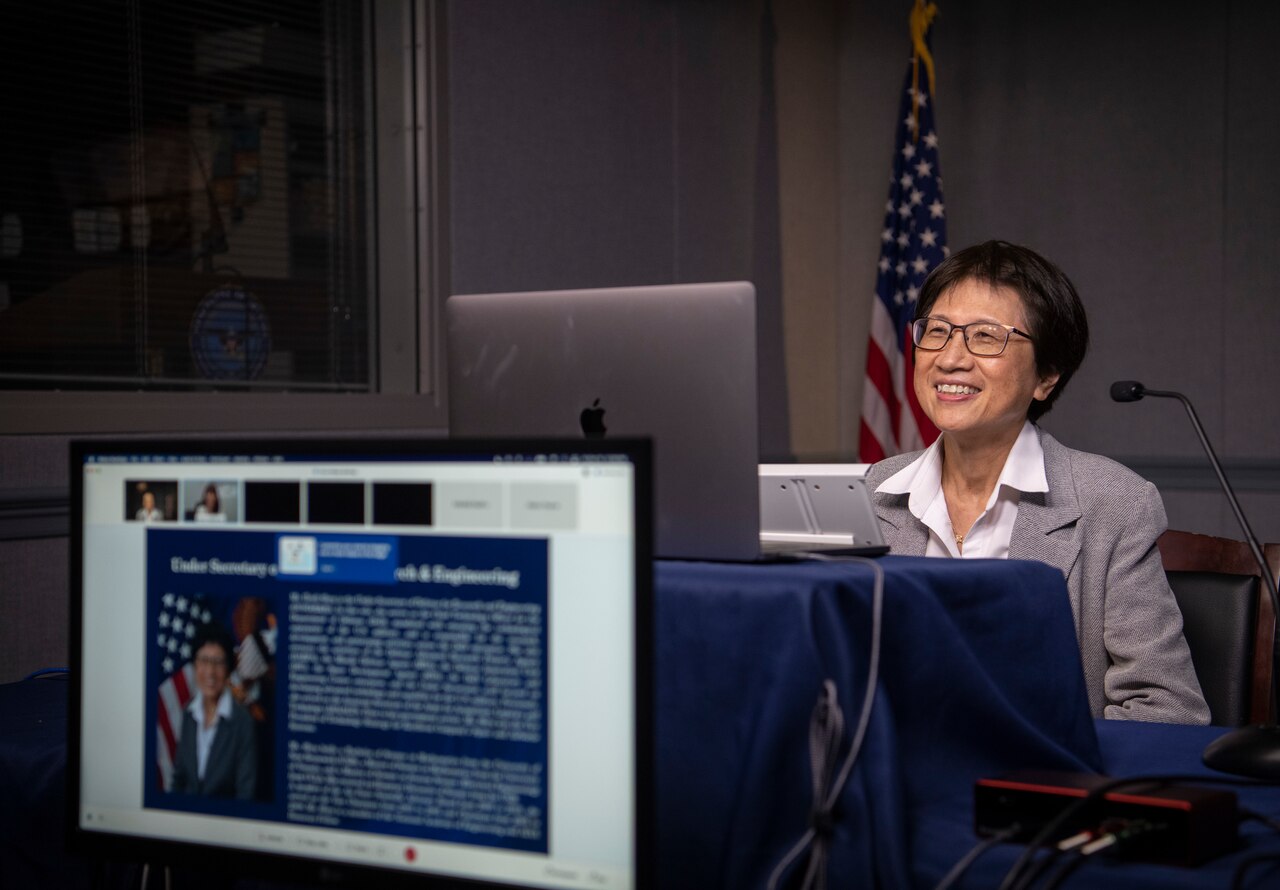 A woman speaks at a virtual conference.