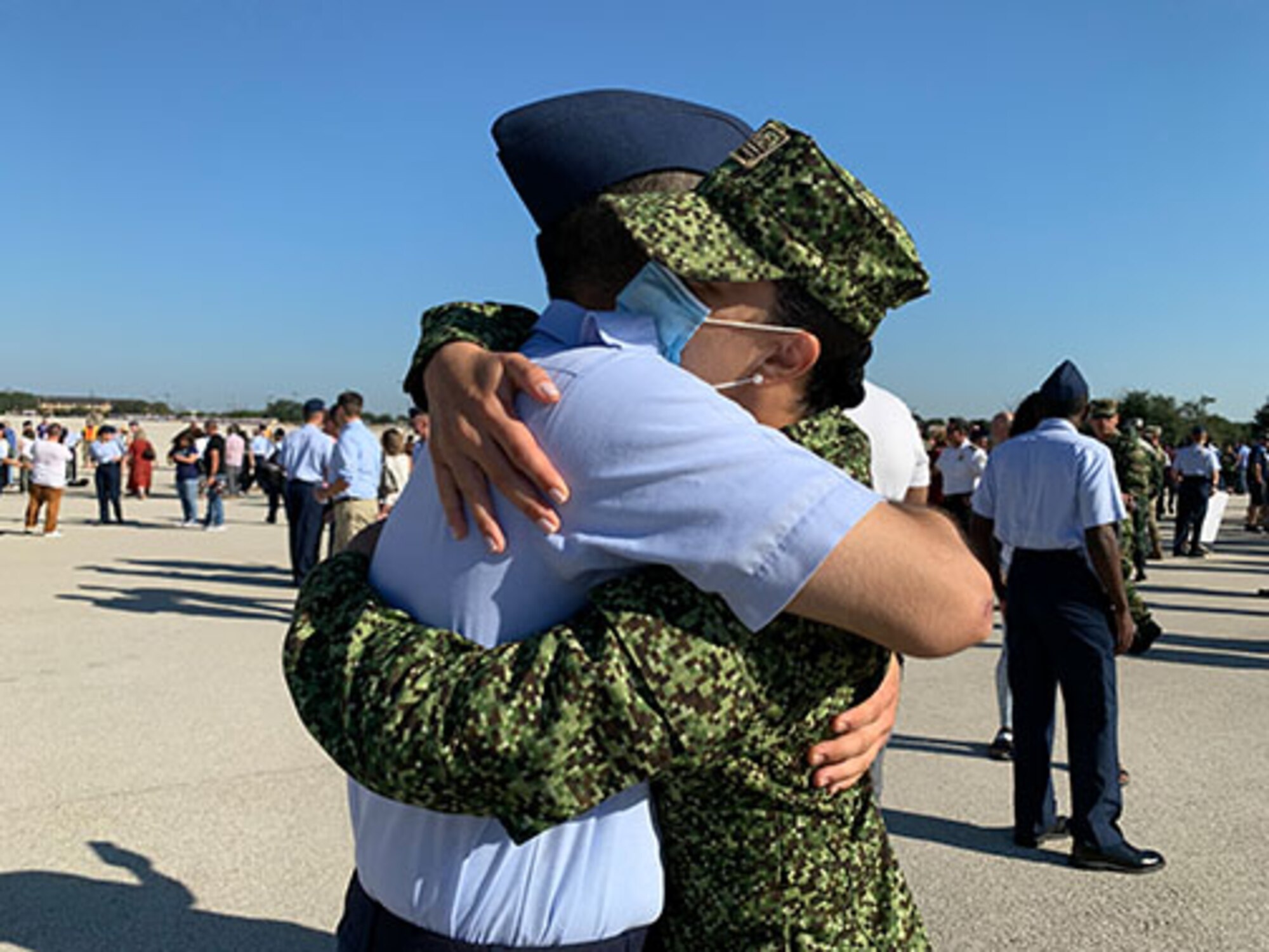 Colombian Navy officer hugs Airman after BMT graduation.
