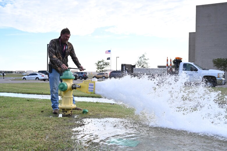 Man standing by fire hydrant