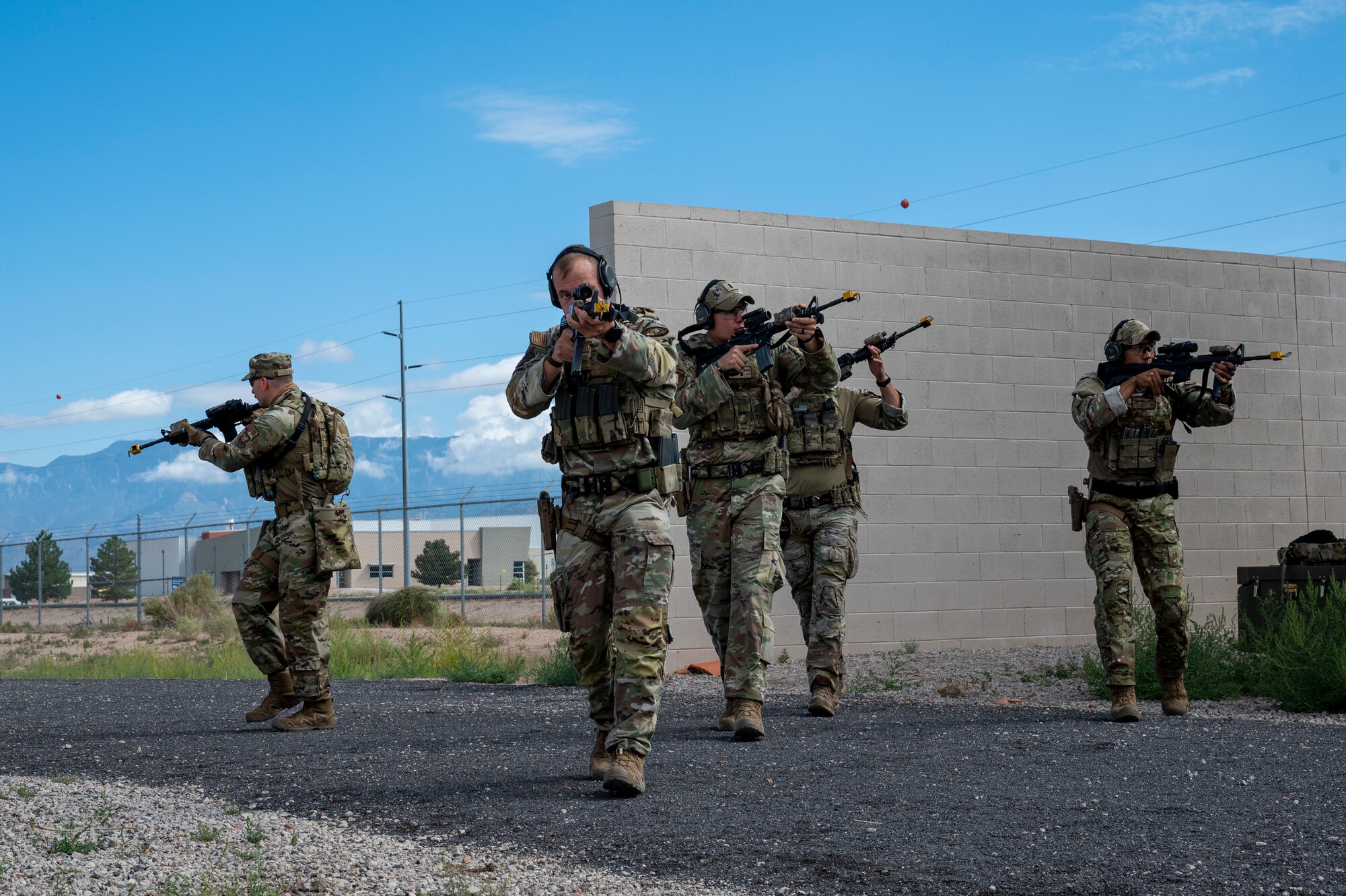 SFS team members approach a building in formation
