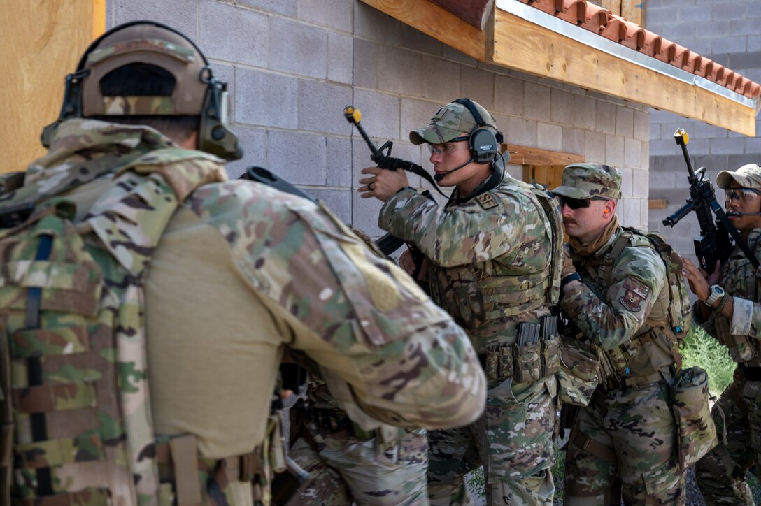 SFS team members prepare to breach a building