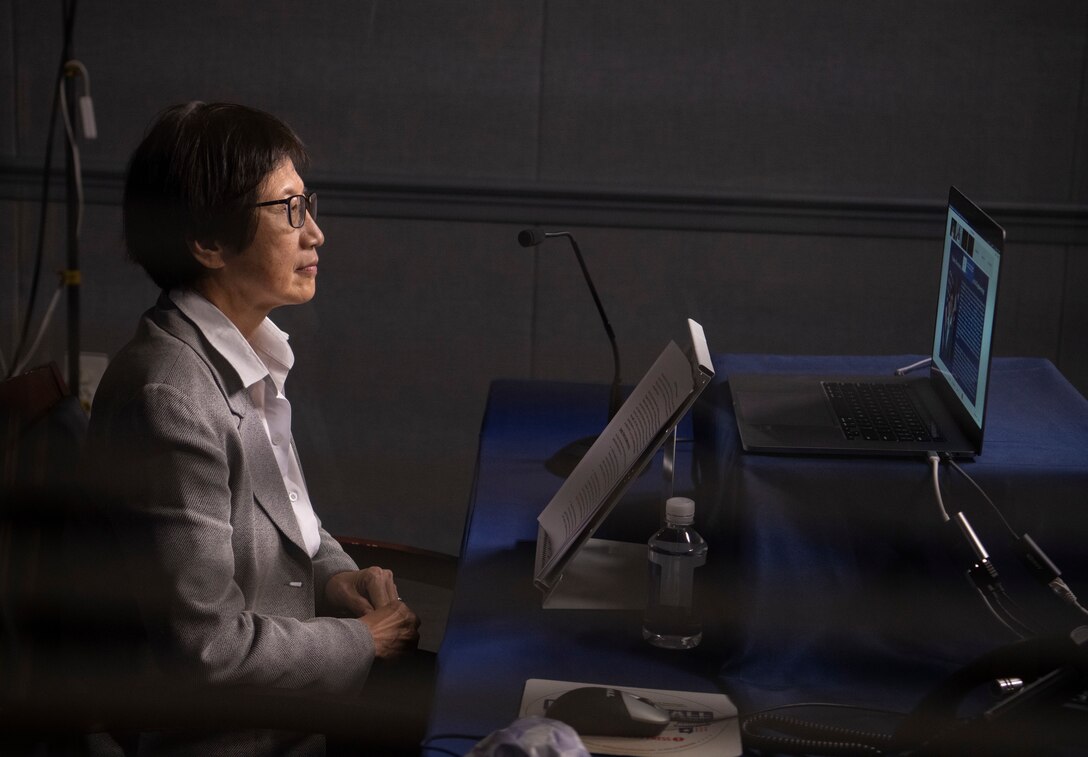 A woman speaks at a virtual conference.