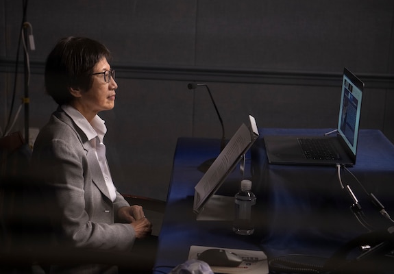 A woman speaks at a virtual conference.