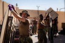 Sailors assigned to U.S. Naval Forces Central Command and Coastguardsmen assigned to Patrol Forces Southwest Asia participate in a community relations (COMREL) event at Bahrain Mobility International (BMI) in Isa Town, Oct 16. During the COMREL, more than 80 participants from multiple commands volunteered to assist with cleanup efforts, beautification projects and interactive programs with children.