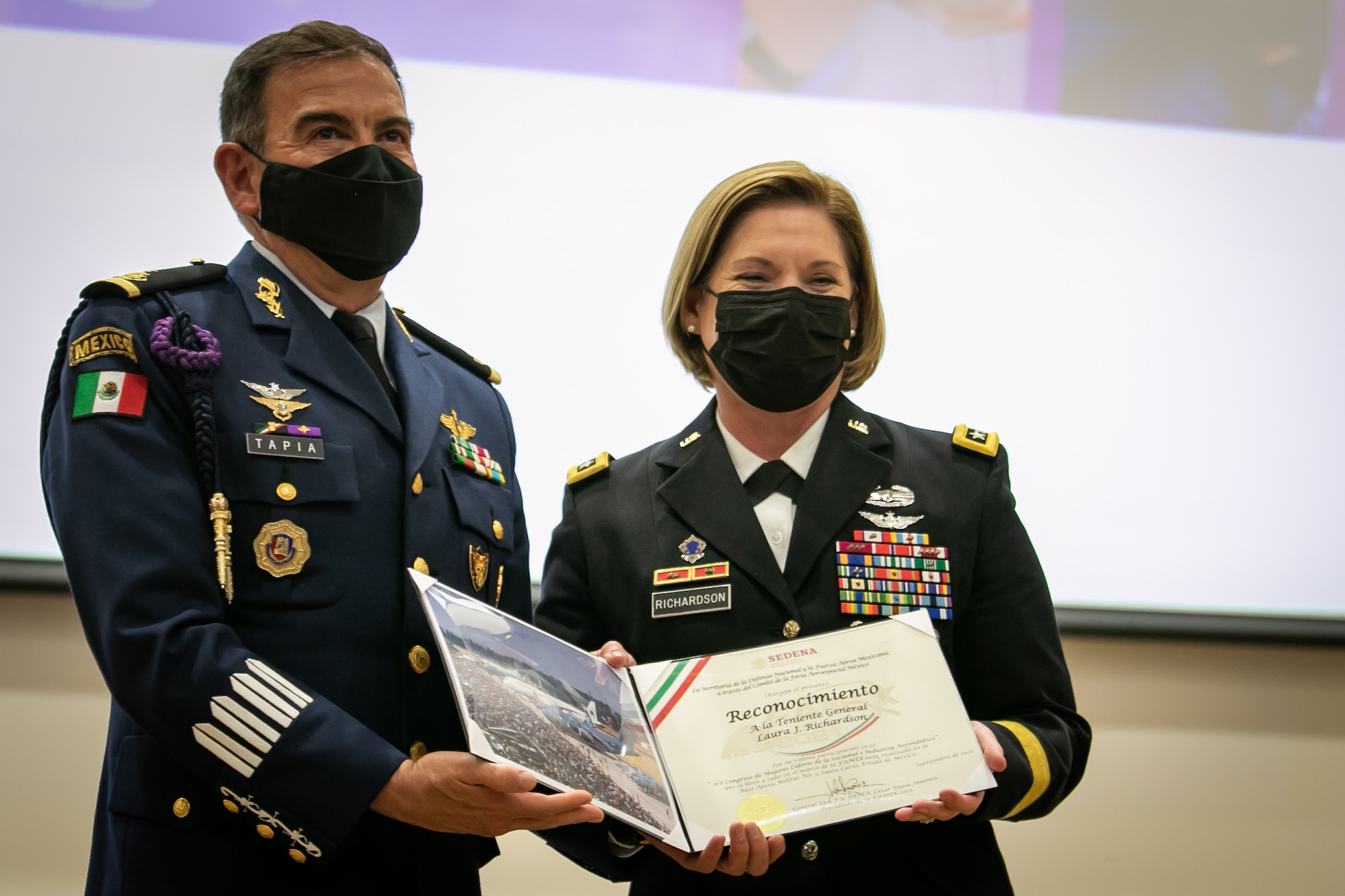 Members of the Mexican armed forces applaud a speaker during the Women in Aerospace and Society Leadership Conference at Base Aérea No.1 de Santa Lucía, Mexico, Sep. 24, 2021. The event was hosted by the Mexican Secretariat of National Defense (SEDENA) and was meant to provide a forum for women leaders to share experiences and inspire future generations of women to pursue leadership opportunities. (U.S. Air Force photo by 2nd Lt. Danny Rangel)