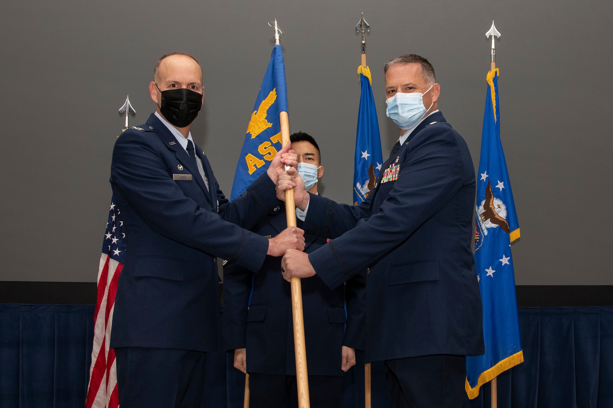 Col Zidek passes the 302nd Aeromedical Staging Squadron guidon to Lt. Col. Bershinsky