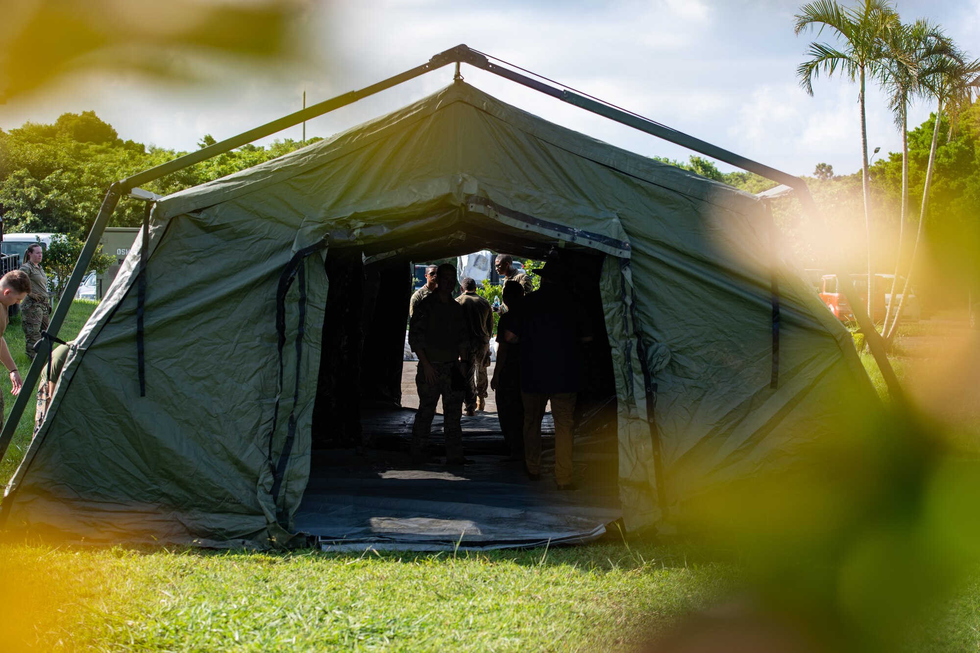 An Air Transportable Treatment Unit sits completed peeking from some foliage