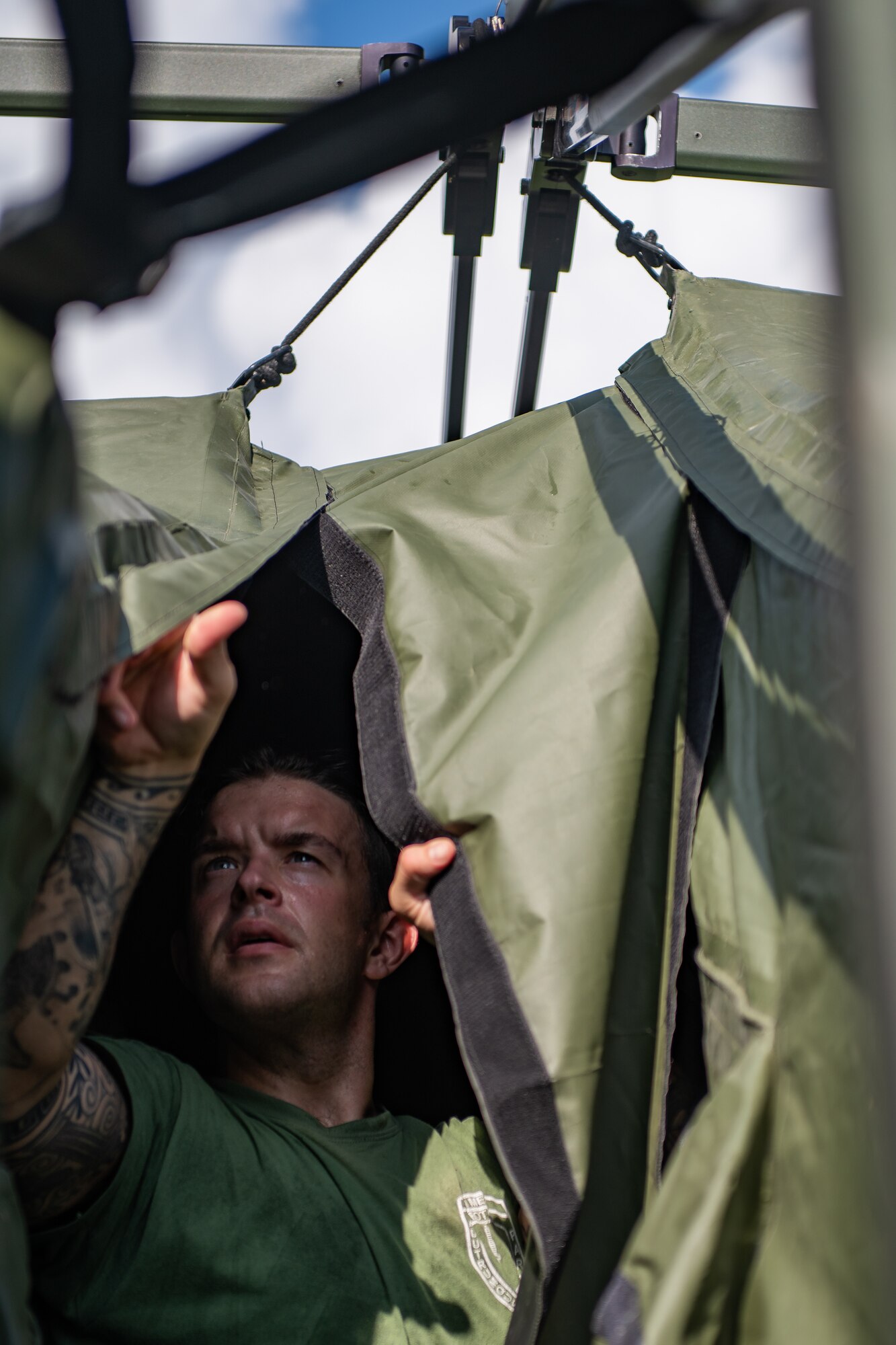 A man attaches Velcro flaps for two tents