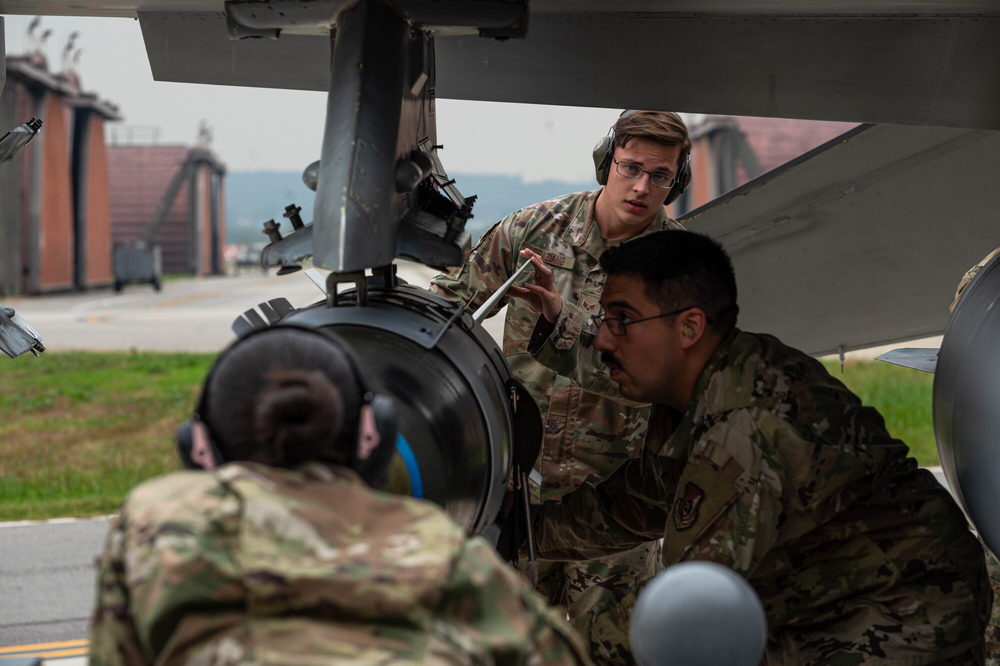 51st Maintenance Group loads a munition onto an F-16 at the 3rd quarter load competition