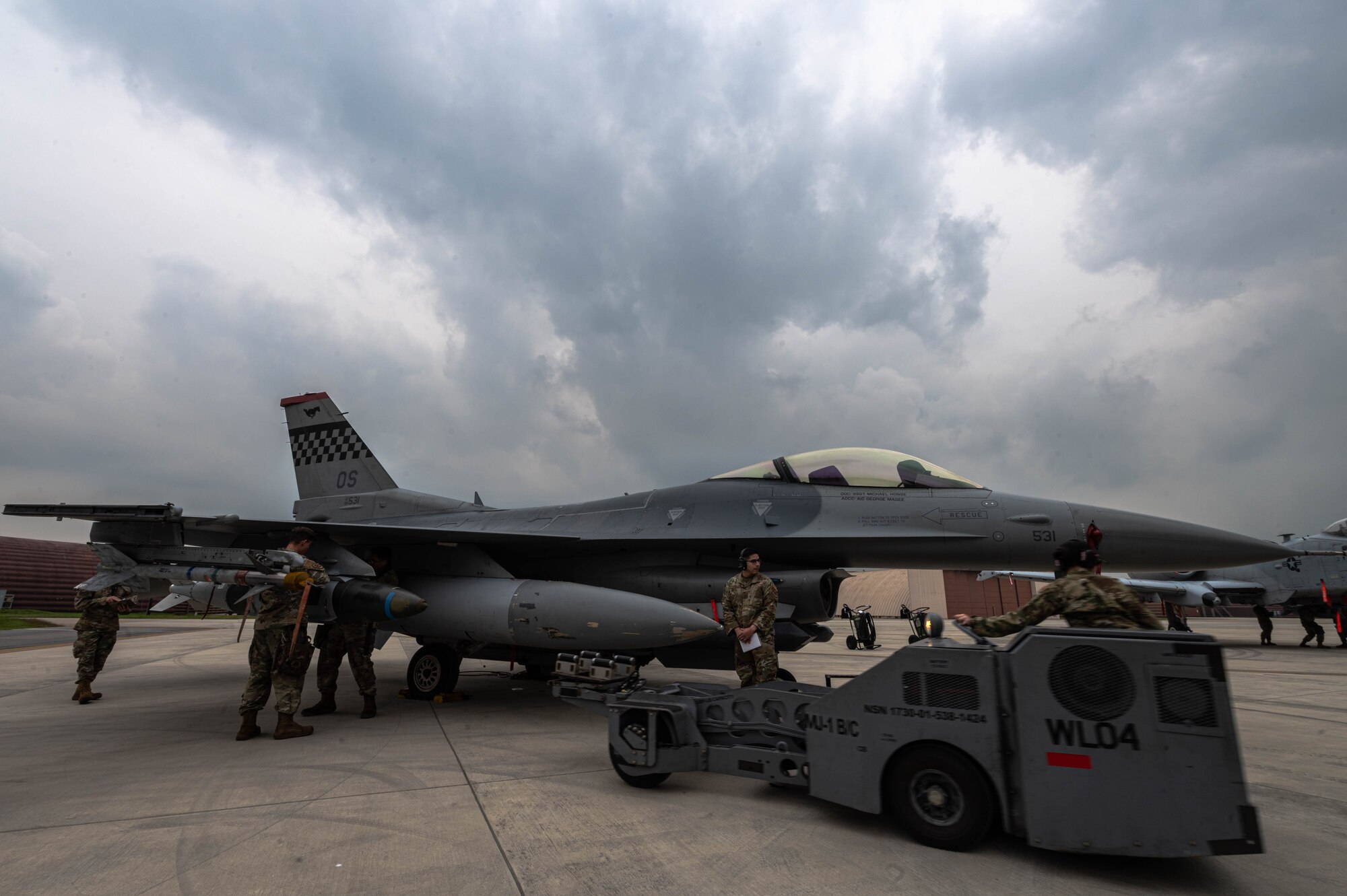 51st Maintenance Group loads a munition onto an F-16 at the 3rd quarter load competition