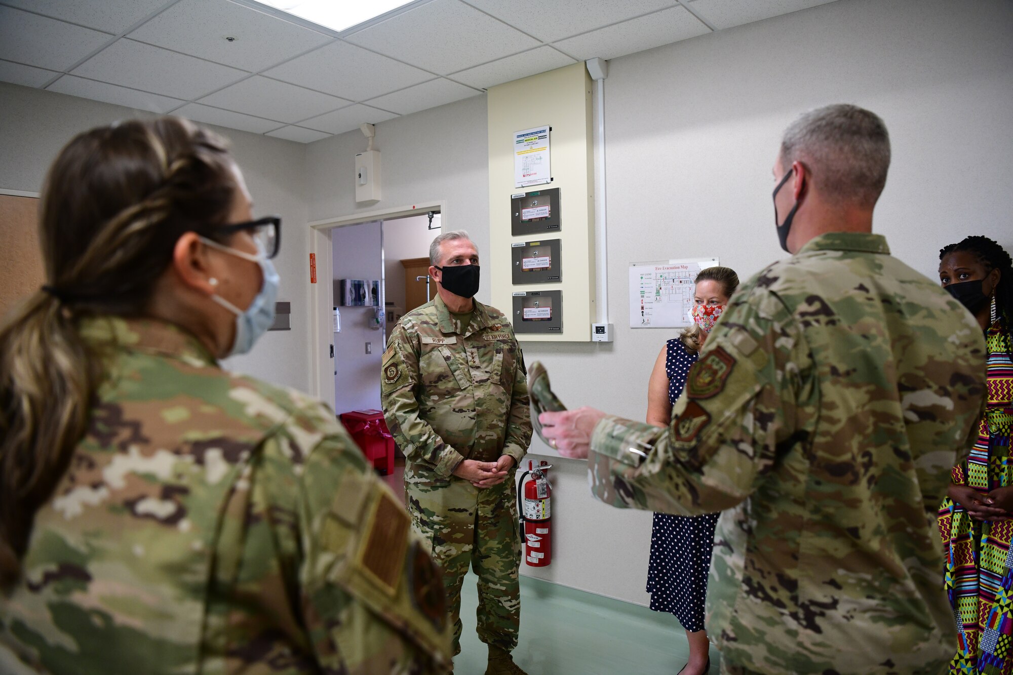 Lt. Gen. Ricky Rupp is briefed by 374th Medical Group Airmen