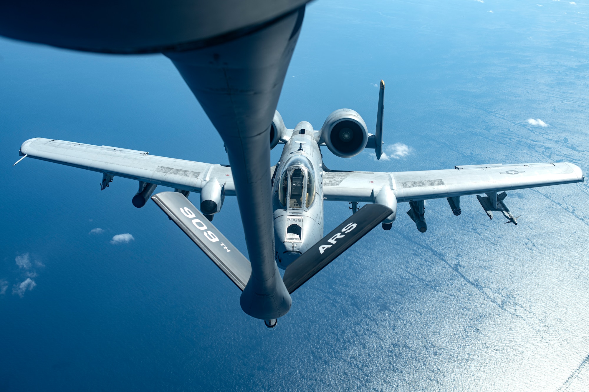 A U.S. Air Force A-10 Thunderbolt II from the 51st Fighter Squadron approaches a 909th Air Refueling Squadron KC-135 Stratotanker for aerial refueling over the Pacific Ocean Oct. 14, 2021. The A-10s were on a combat search and rescue training mission from Osan Air Base, Republic of Korea. (U.S. Air Force photo by Senior Airman Jessi Monte)