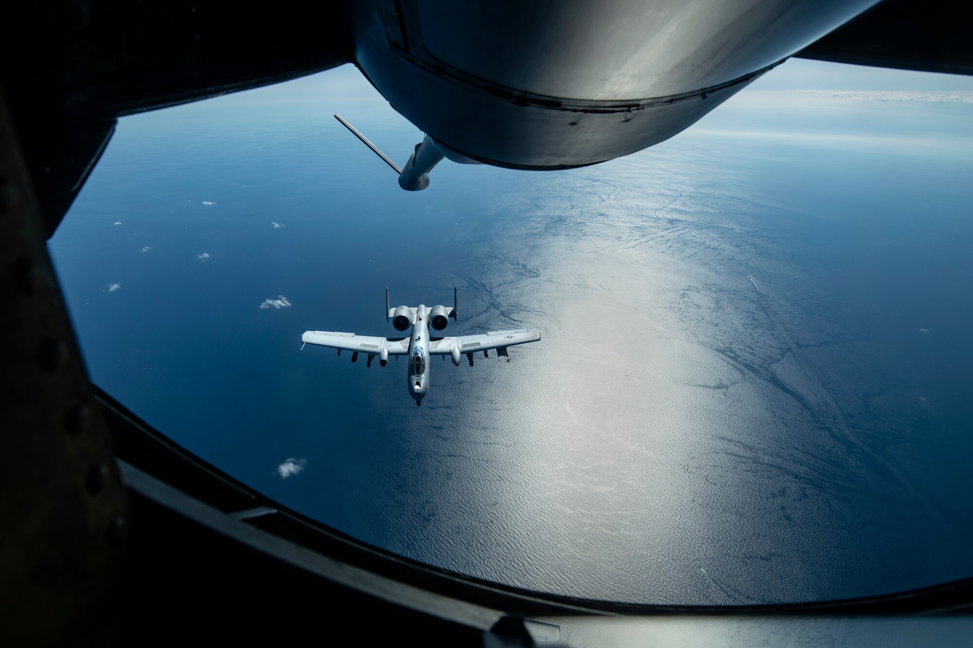 A U.S. Air Force A-10 Thunderbolt II from the 51st Fighter Squadron approaches a 909th Air Refueling Squadron KC-135 Stratotanker for aerial refueling over the Pacific Ocean Oct. 14, 2021. The A-10 derives its name from the World War II era Republic P-47 Thunderbolt, which was also designed for attacking ground targets. (U.S. Air Force photo by Senior Airman Jessi Monte)