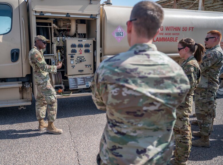 U.S. Air Force Staff Sgt. Raymond Randall, a fuels facility technician assigned to the 386th Expeditionary Logistics Readiness Squadron, discusses fuel operations with Airmen at Ali Al Salem Air Base, Kuwait, on Oct. 15, 2021.