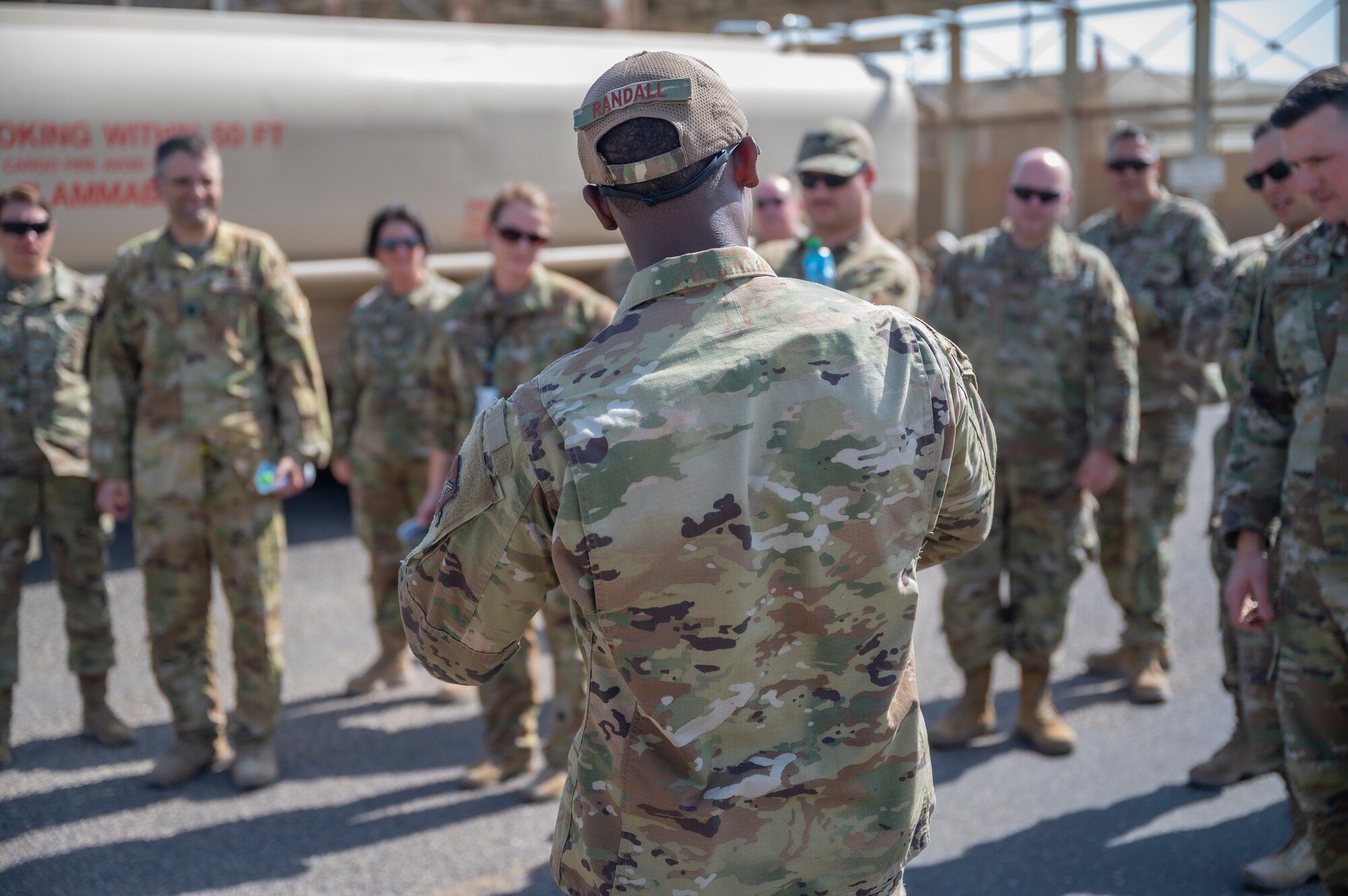 U.S. Air Force Staff Sgt. Raymond Randall, a fuels facility technician assigned to the 386th Expeditionary Logistics Readiness Squadron, discusses fuel operations with Airmen at Ali Al Salem Air Base, Kuwait, on Oct. 15, 2021.