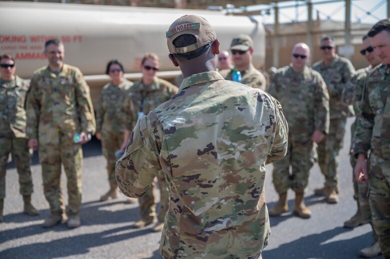 U.S. Air Force Staff Sgt. Raymond Randall, a fuels facility technician assigned to the 386th Expeditionary Logistics Readiness Squadron, discusses fuel operations with Airmen at Ali Al Salem Air Base, Kuwait, on Oct. 15, 2021.