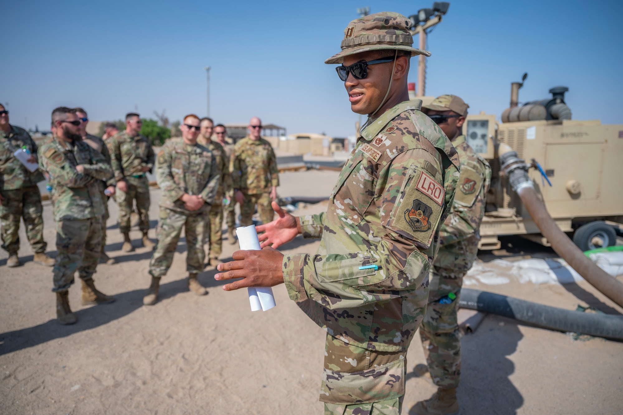 U.S. Air Force Capt. Andrew McGee, vehicle management and petroleum, oil and lubricants flight commander assigned to the 386th Expeditionary Logistics Readiness Squadron, discusses fuel operations with Airmen at Ali Al Salem Air Base, Kuwait, on Oct. 15, 2021.