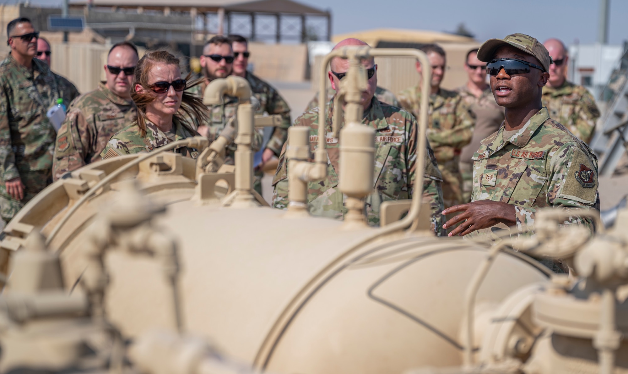 U.S. Air Force Staff Sgt. Raymond Randall, a fuels facility technician assigned to the 386th Expeditionary Logistics Readiness Squadron, discusses fuel operations with Airmen at Ali Al Salem Air Base, Kuwait, on Oct. 15, 2021.
