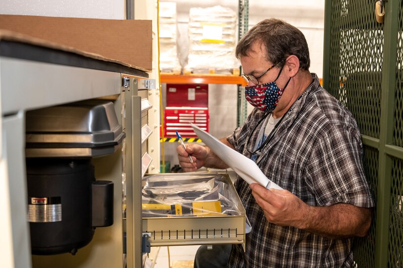 Photo of Sheet Metal Mechanic Paul Dick inventorying equipment in an Armament Repair Shop Set