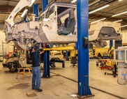 Photo of Canio Lopomo installing a transmission on a High Mobility Multipurpose Wheeled Vehicle (Humvee)