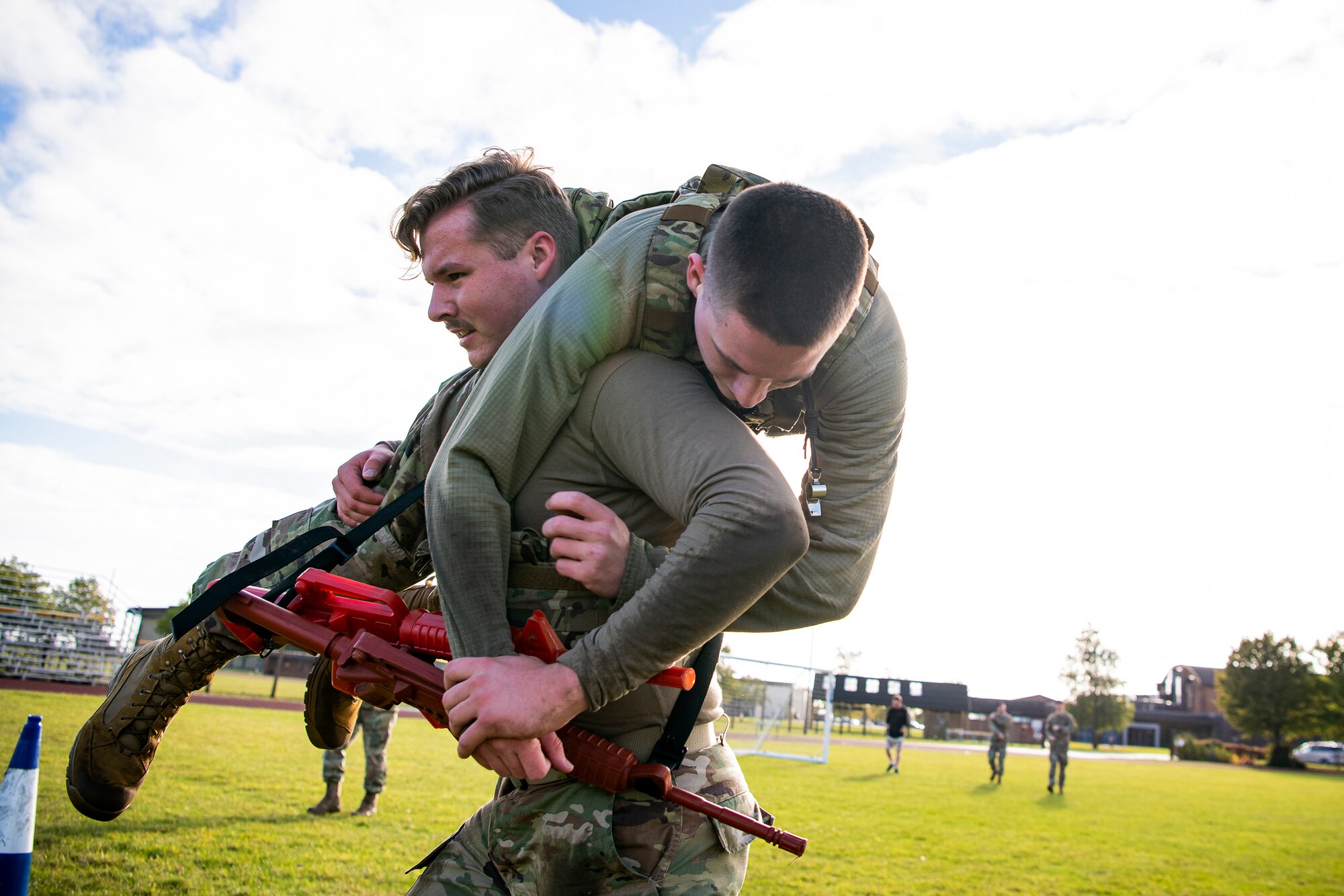 Airman 1st Class Garrett Allen, left, 423rd Security Forces Squadron patrolman, carries Airman 1st Class Aidan Holt, 423rd SFS installation patrolman, as part of a defender challenge at RAF Alconbury, England, Oct. 13, 2021. The challenge was part of National Police Week where defenders paid homage to those who have served as police officers and to honor those that lost their lives in the line of duty. (U.S. Air Force photo by Senior Airman Eugene Oliver)