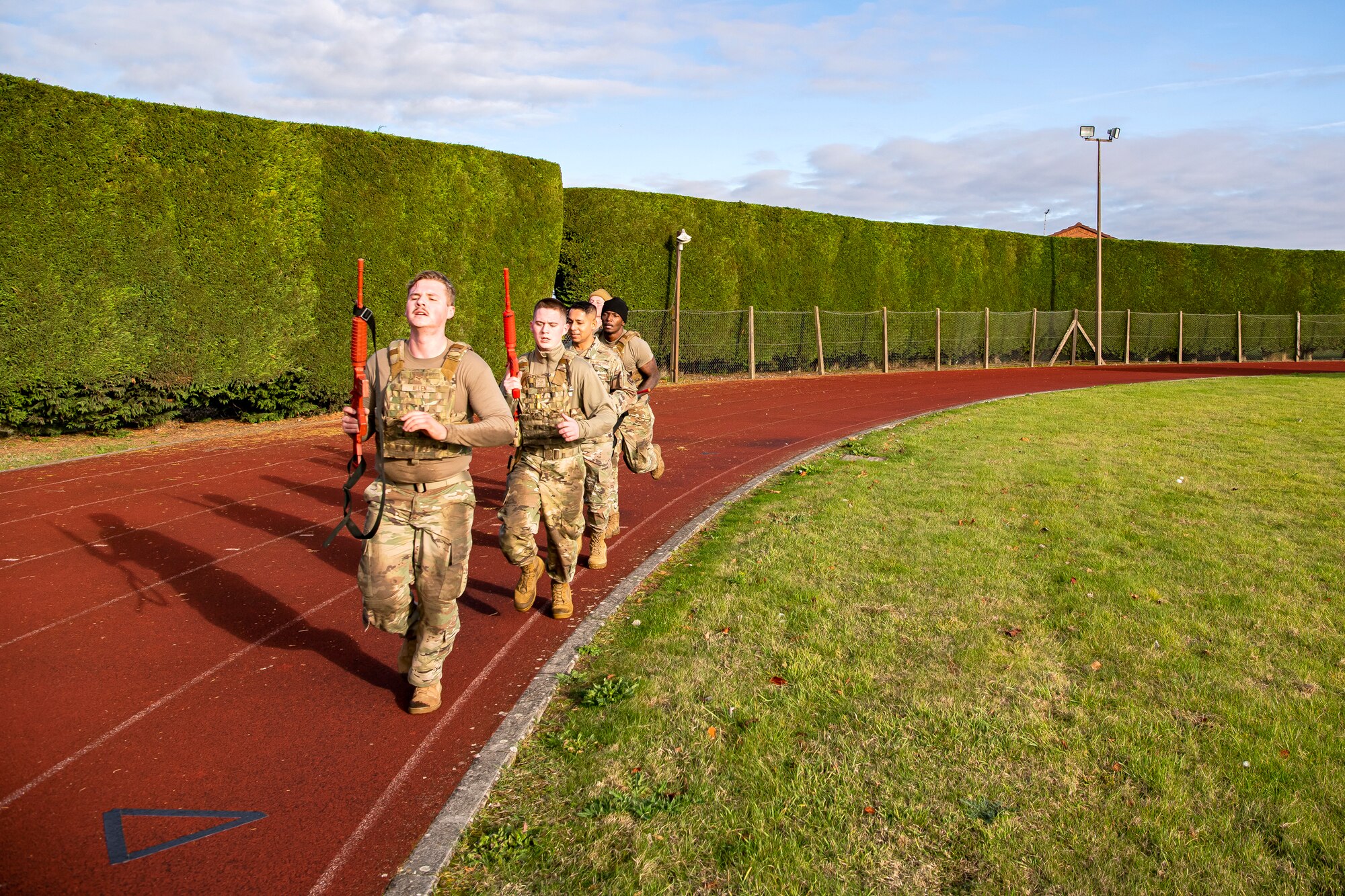 Airmen from the 423rd Security Forces Squadron run a lap as part of a defender challenge at RAF Alconbury, England, Oct. 13, 2021. The challenge was part of National Police Week where defenders paid homage to those who have served as police officers and to honor those that lost their lives in the line of duty. (U.S. Air Force photo by Senior Airman Eugene Oliver)