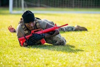 U.S. Air Force Staff Sgt. Jaylon Darden, 423rd Security Forces Squadron flight sergeant, low crawls as part of a defender challenge at RAF Alconbury, England, Oct. 13, 2021. The challenge was part of National Police Week where defenders paid homage to those who have served as police officers and to honor those that lost their lives in the line of duty. (U.S. Air Force photo by Senior Airman Eugene Oliver)