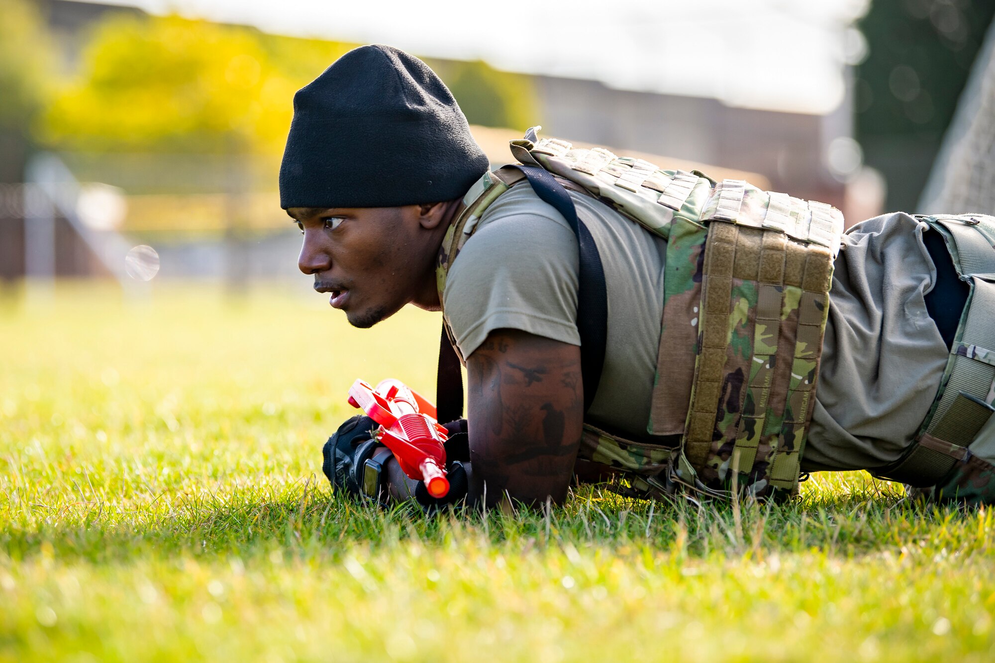 U.S. Air Force Staff Sgt. Jaylon Darden, 423rd Security Forces Squadron flight sergeant, low crawls as part of a defender challenge at RAF Alconbury, England, Oct. 13, 2021. The challenge was part of National Police Week where defenders paid homage to those who have served as police officers and to honor those that lost their lives in the line of duty. (U.S. Air Force photo by Senior Airman Eugene Oliver)