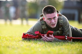 Airman 1st Class Aidan Holt, 423rd Security Forces Squadron installation patrolman, low crawls as part of a defender challenge at RAF Alconbury, England, Oct. 13, 2021. The challenge was part of National Police Week where defenders paid homage to those who have served as police officers and to honor those that lost their lives in the line of duty. (U.S. Air Force photo by Senior Airman Eugene Oliver)