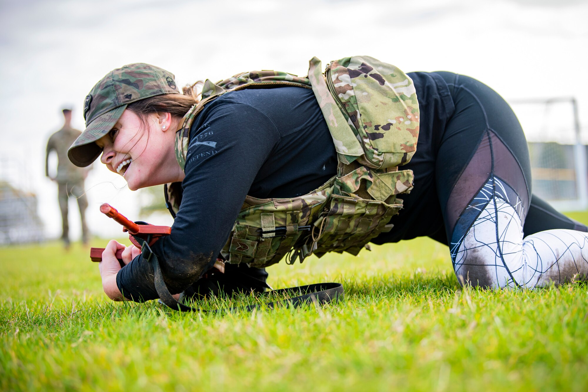 U.S. Air Force Staff Sgt. Meghan Ballard, 423rd Security Forces Squadron NCO in charge of pass and registration, low crawls as part of a defender challenge at RAF Alconbury, England, Oct. 13, 2021. The challenge was part of National Police Week where defenders paid homage to those who have served as police officers and to honor those that lost their lives in the line of duty. (U.S. Air Force photo by Senior Airman Eugene Oliver)