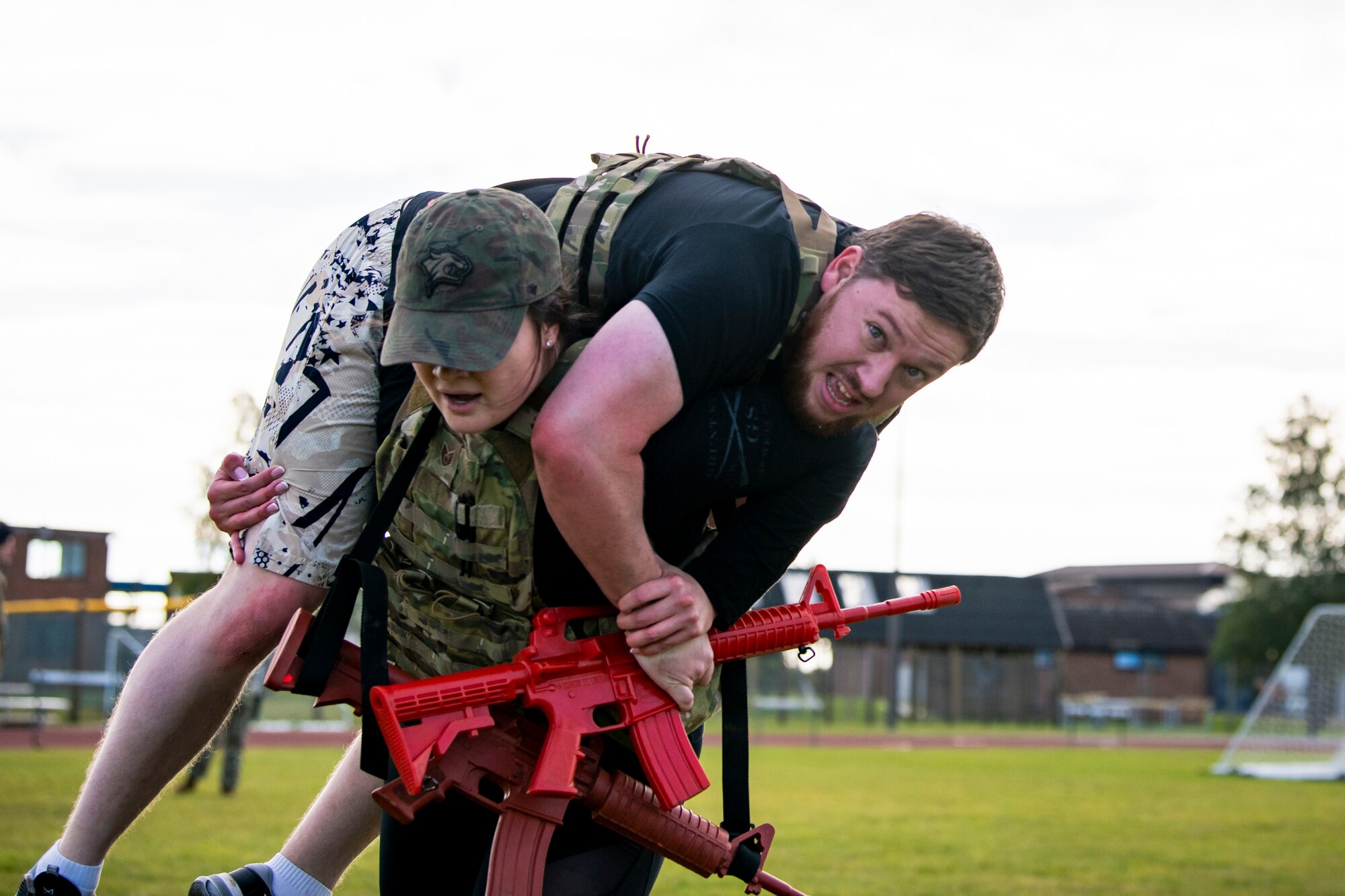 U.S. Air Force Staff Sgt. Meghan Ballard, 423rd Security Forces Squadron NCO in charge of pass and registration, carries Luke Young, 423d SFS resource protection program manager, as part of a defender challenge at RAF Alconbury, England, Oct. 13, 2021. The challenge was part of National Police Week where defenders paid homage to those who have served as police officers and to honor those that lost their lives in the line of duty. (U.S. Air Force photo by Senior Airman Eugene Oliver)