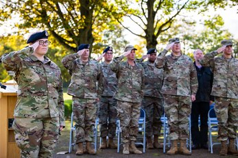 Airmen from the 501st Combat Support Wing salute during a retreat ceremony at RAF Croughton, England, Oct. 15, 2021. The ceremony concluded Police Week in which defenders from the 422d and 423rd Security Forces Squadrons paid homage to those who lost their lives in the line of duty. (U.S. Air Force photo by Senior Airman Eugene Oliver)