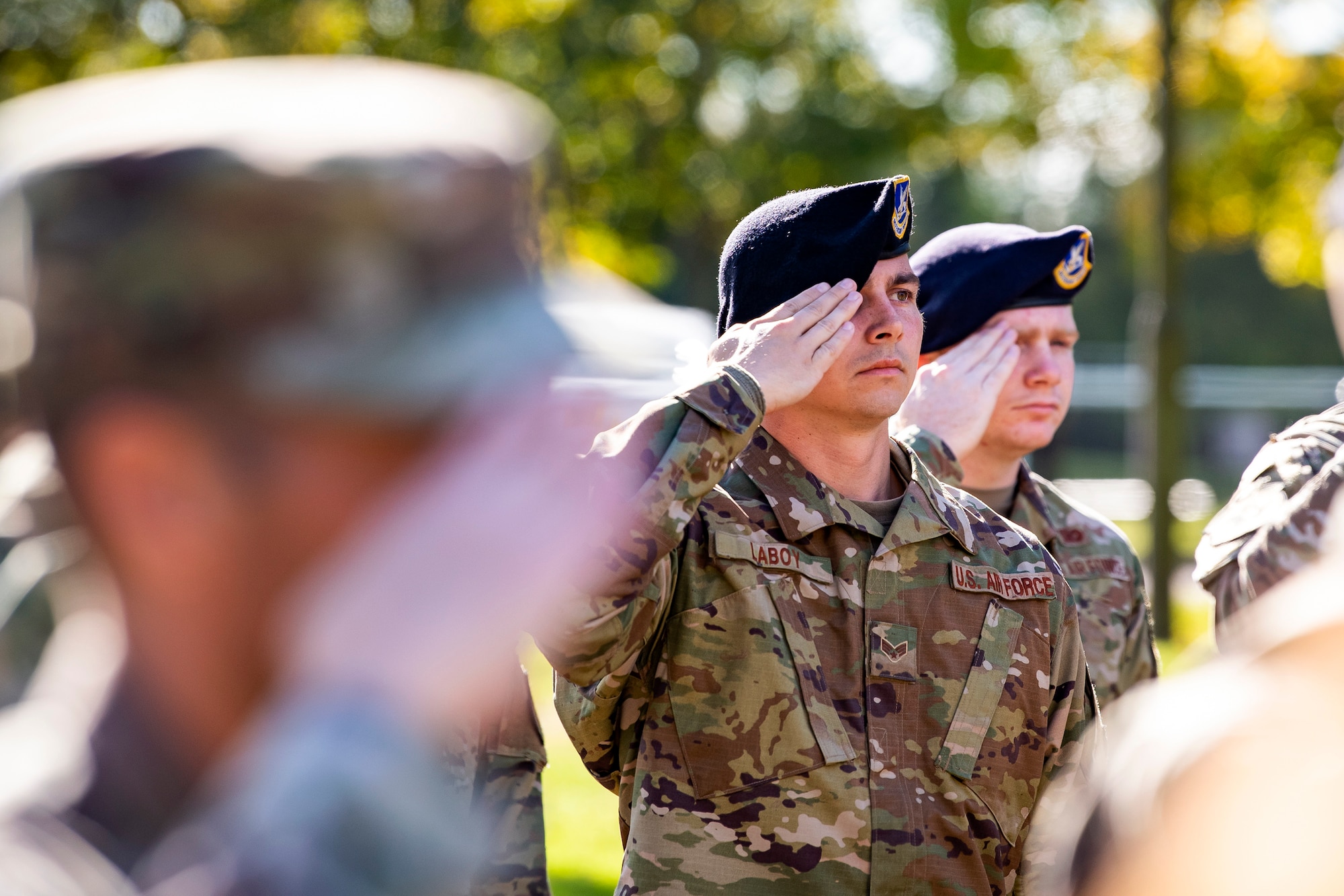 Airmen from the 422d Security Forces Squadron salute during a retreat ceremony at RAF Croughton, England, Oct. 15, 2021.  The ceremony concluded Police week in which defenders from the 422d and 423rd SFS paid homage to those who lost their lives in the line of duty. (U.S. Air Force photo by Senior Airman Eugene Oliver)