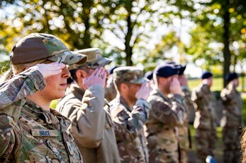 Airmen from the 501st Combat Support Wing salute during a retreat ceremony at RAF Croughton, England, Oct. 15, 2021.  The ceremony concluded Police Week in which defenders from the 422d and 423rd Security Forces Squadrons paid homage to those who lost their lives in the line of duty. (U.S. Air Force photo by Senior Airman Eugene Oliver)
