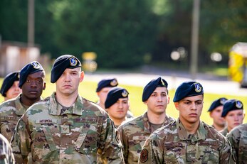 Airmen from the 422d Security Forces Squadron stand in formation during a retreat ceremony at RAF Croughton, England, Oct. 15, 2021. The ceremony concluded Police week in which defenders from the 422d and 423rd SFS paid homage to those who lost their lives in the line of duty. (U.S. Air Force photo by Senior Airman Eugene Oliver)