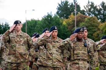 Airmen from the 422d Security Forces Squadron salute during a retreat ceremony at RAF Croughton, England, Oct. 15, 2021. The ceremony concluded Police week in which defenders from the 422d and 423rd SFS paid homage to those who lost their lives in the line of duty. (U.S. Air Force photo by Senior Airman Eugene Oliver)