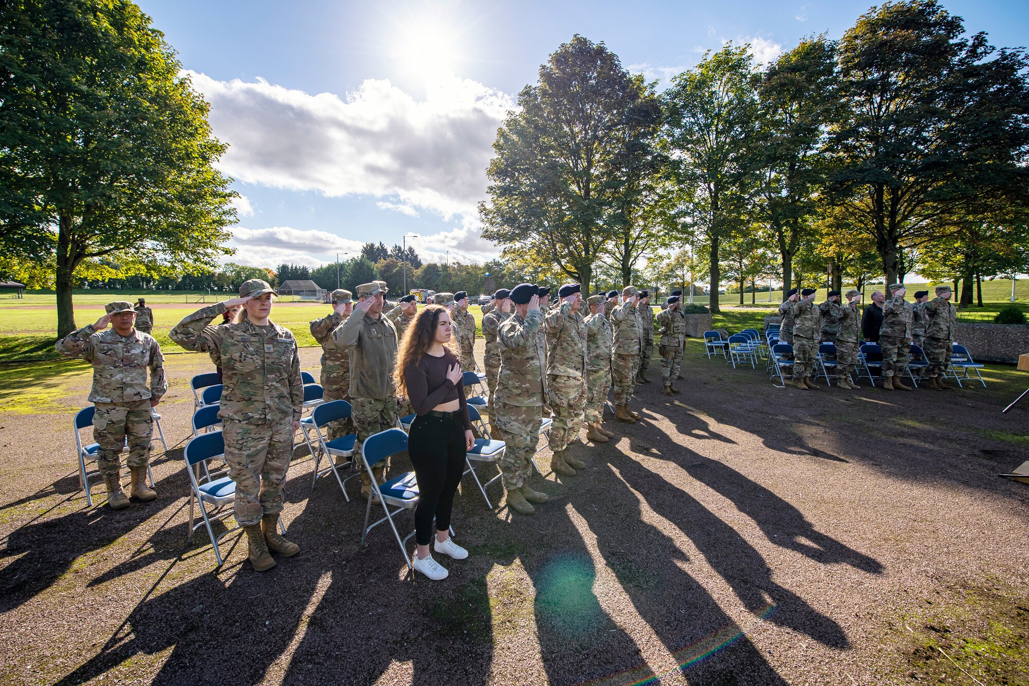 Airmen and guests from the 501st Combat Support Wing salute during a playing of the national anthem at RAF Croughton, England, Oct. 15, 2021.  The ceremony concluded Police week in which defenders from the 422d and 423rd Security Forces Squadrons paid homage to those who lost their lives in the line of duty. (U.S. Air Force photo by Senior Airman Eugene Oliver)