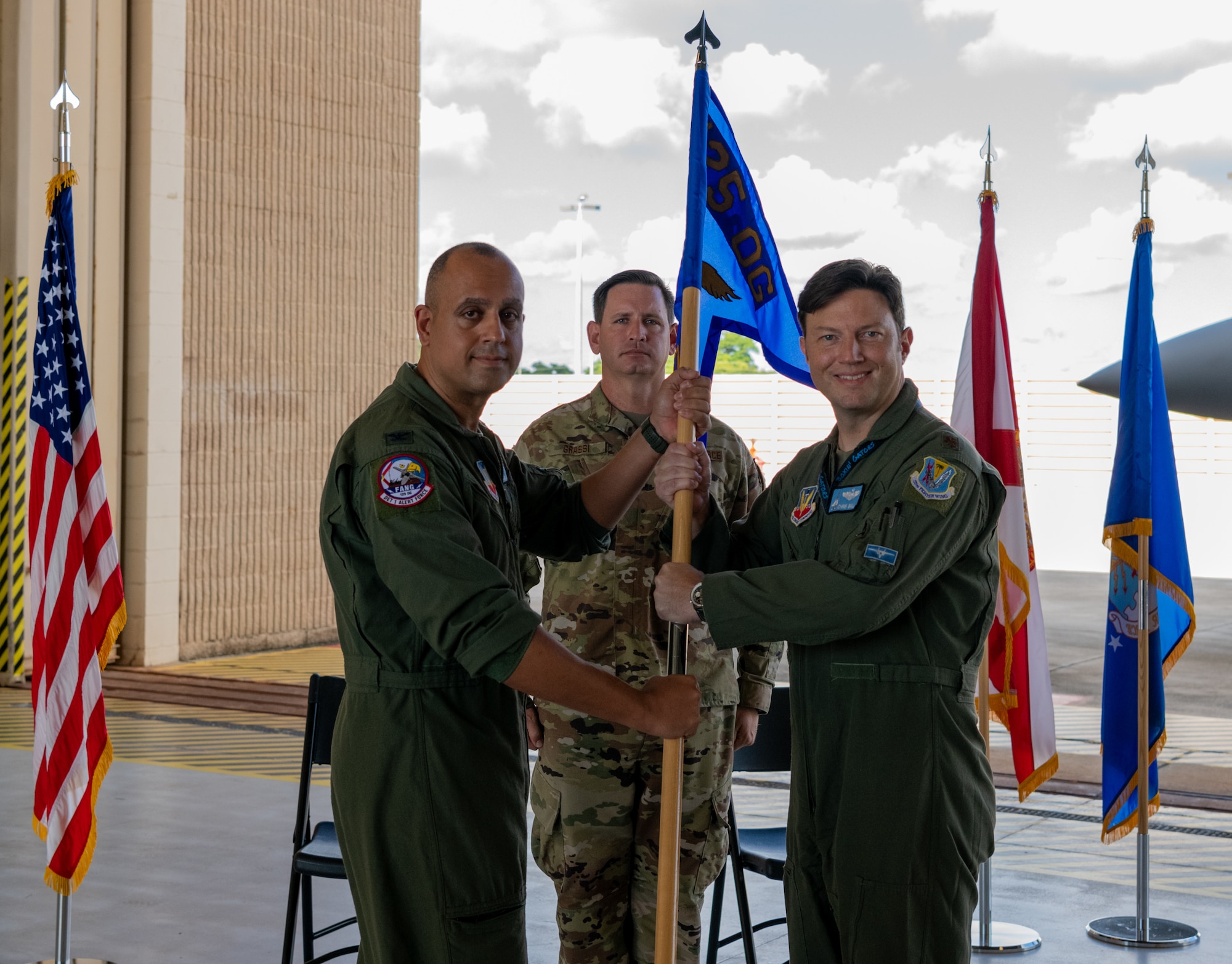 Col. Mansour G. Elhihi, left, 125th Fighter Wing Operation Group commander gives the unit guidon to Maj. Christopher Bell, Detachment 1, 125th FW commander during an assumption of command ceremony at Homestead Air Reserve base, Fla., on Oct. 15, 2021. (U.S. Air Force photo by Tech. Sgt. Allissa Landgraff)