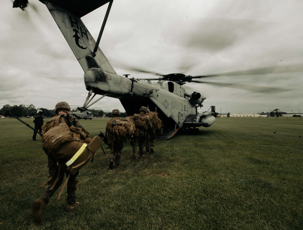 U.S. Marines with 3rd Battalion, 6th Marine Regiment, 2d Marine Division, load on to a CH-53E Super Stallion on Camp Lejeune, N.C., Oct. 13, 2021. The Marines conducted training that included squad-supported day and night live-fire attacks to prepare for future training opportunities with partner nations. (U.S. Marine Corps photo by Lance Cpl. Emma L. Gray)